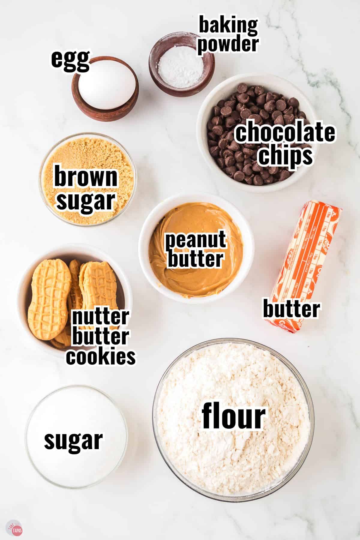 ingredients for a cookie recipe in individual bowls with text overlay labeling them