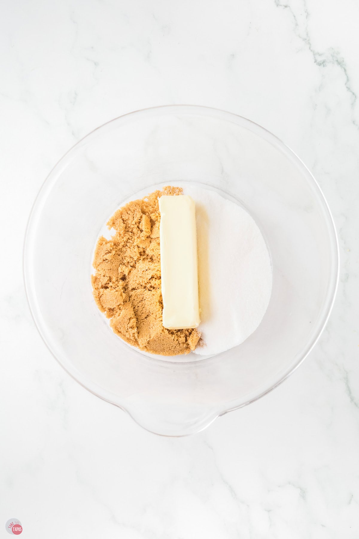 butter and two types of sugar in a clear bowl