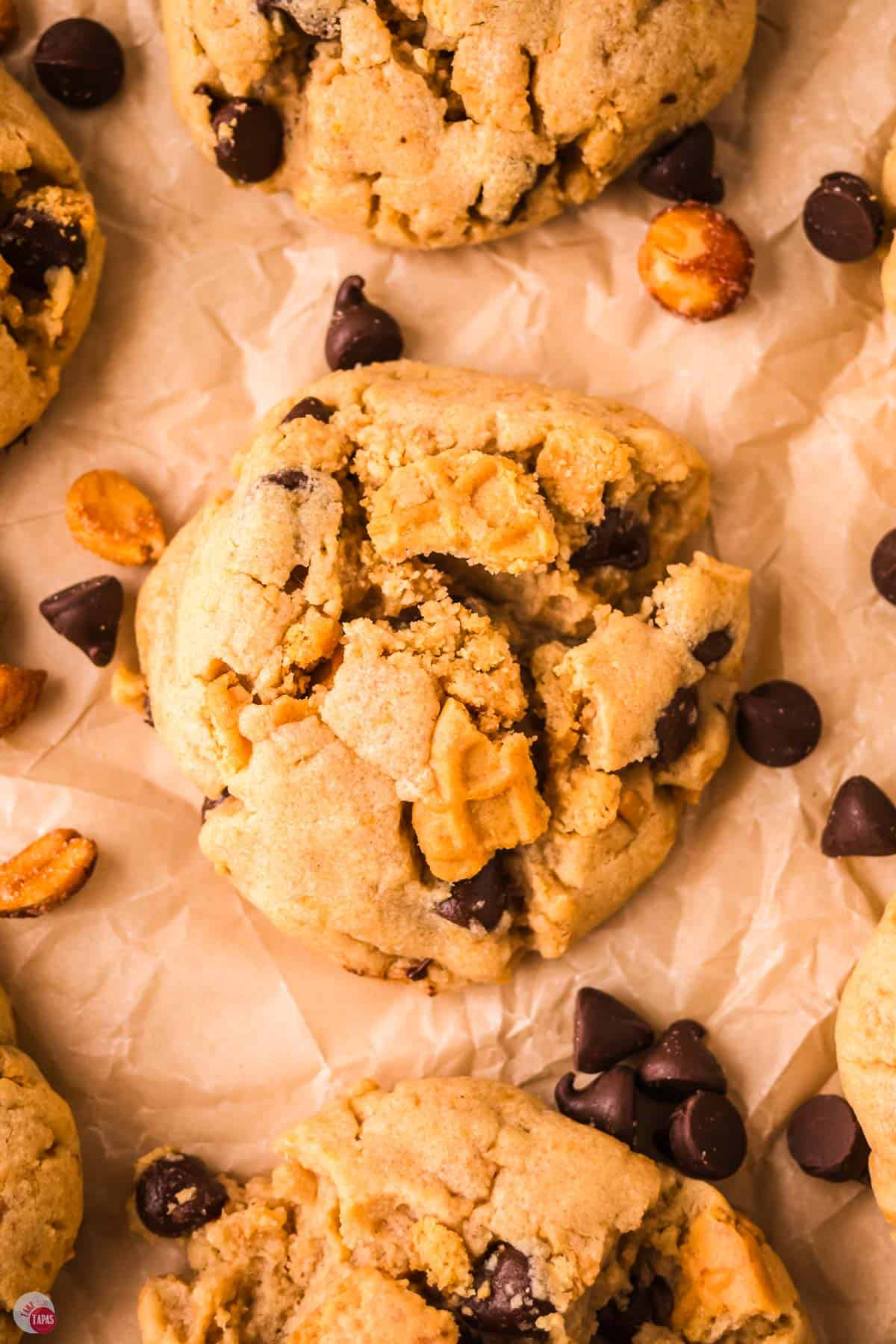 close up of cookie with chocolate and peanut butter on parchment paper
