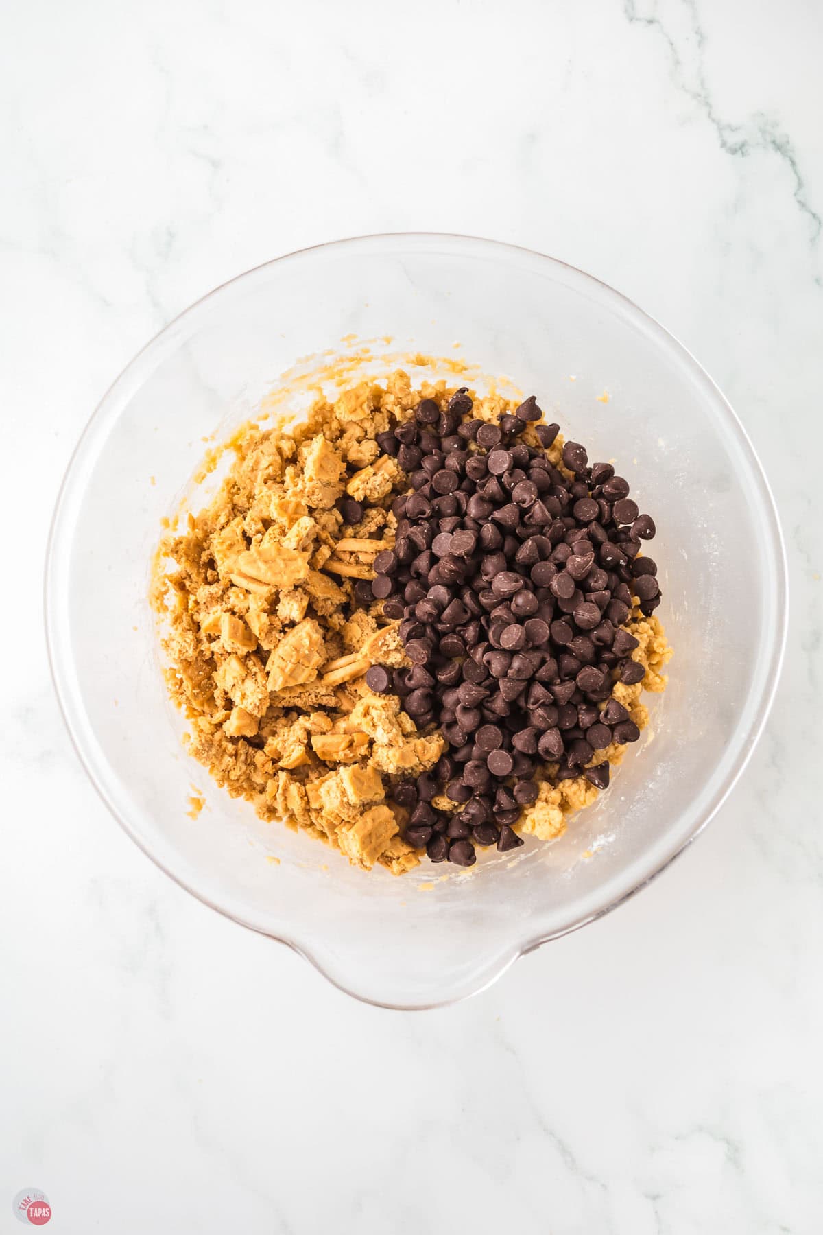 crushed nutter butter cookies and chocolate chips in a clear bowl