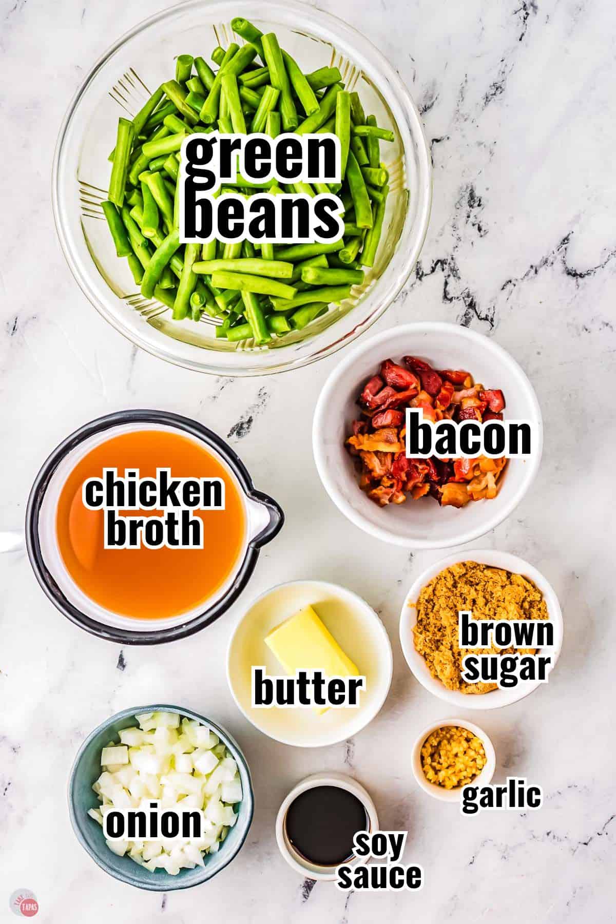 ingredients for a green bean recipe in individual bowls with text overlay labeling them