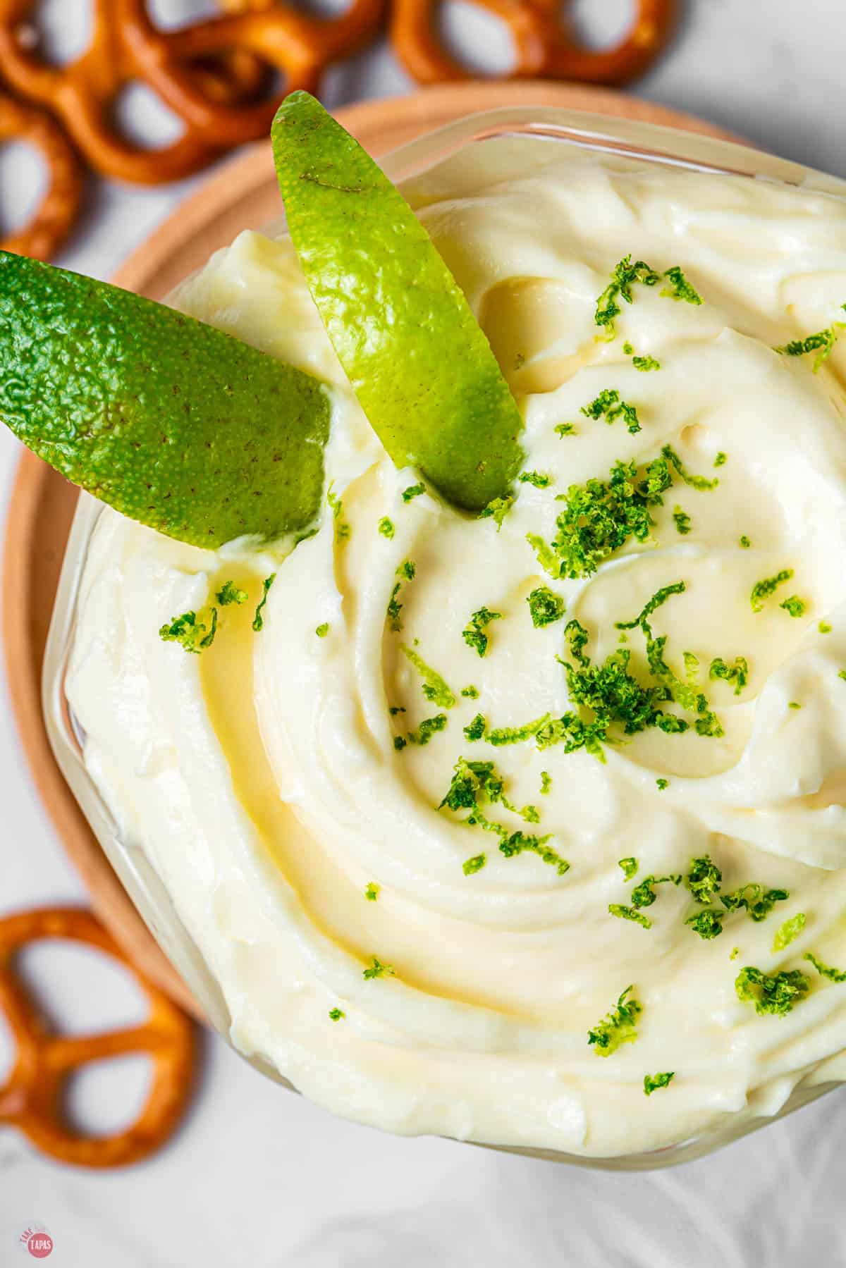 close up of dip in a bowl topped with lime zest