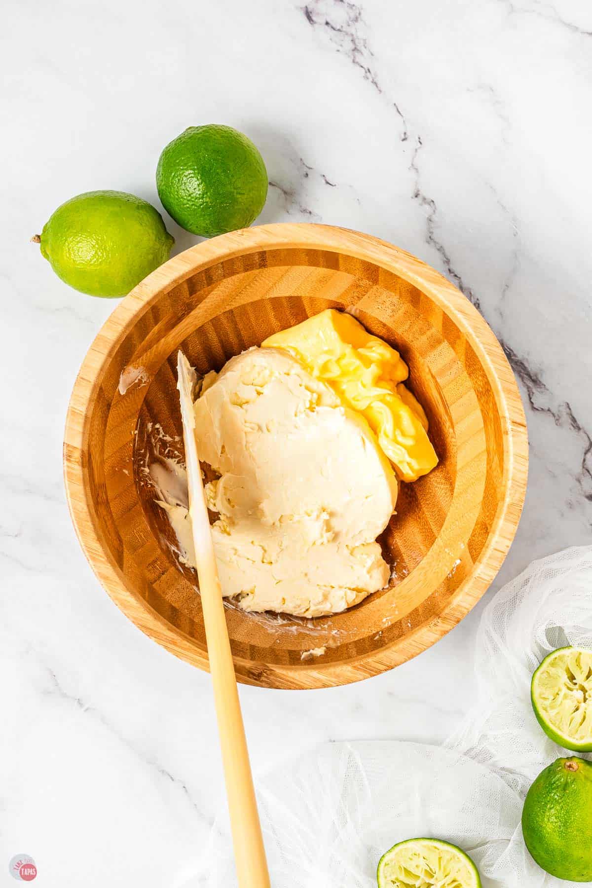 wood bowl with cream cheese and butter being mixed together