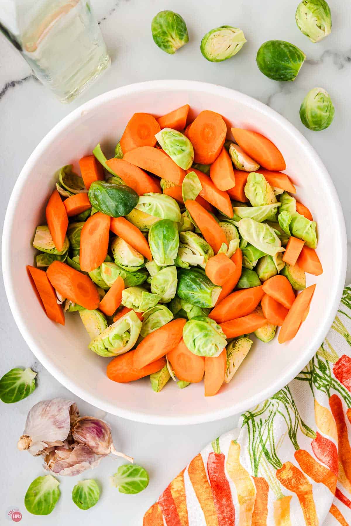 bowl of sliced carrots and trimmed sprouts