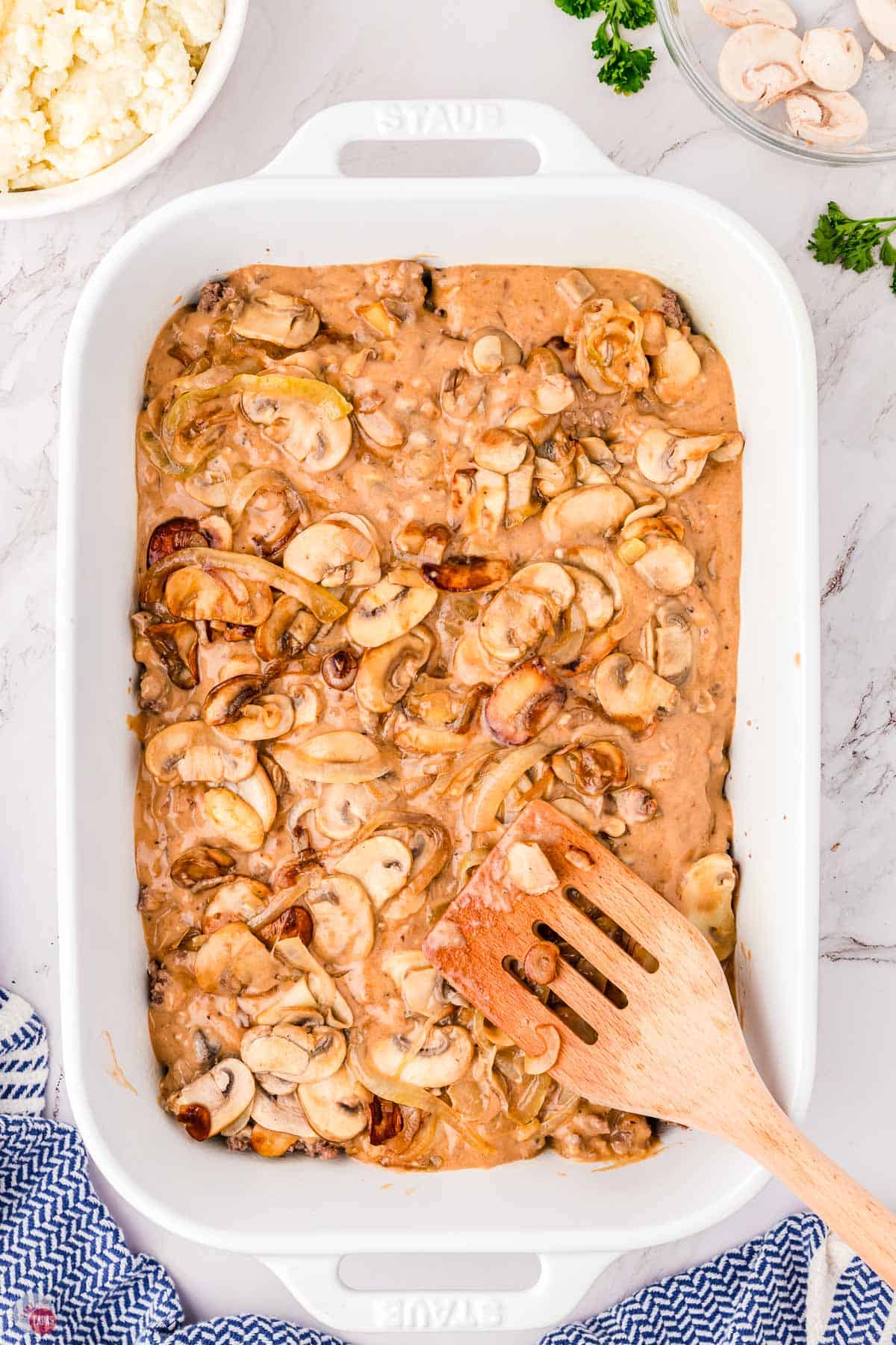 casserole dish with gravy and mushrooms on top
