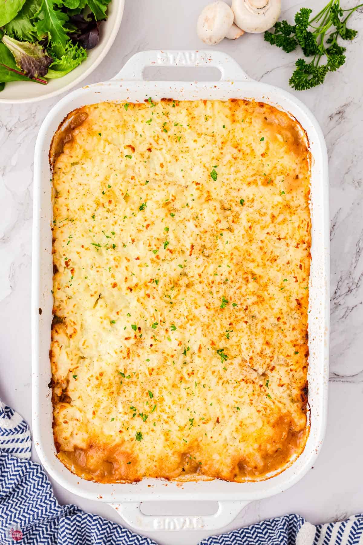 baked salisbury steak casserole in a white baking dish