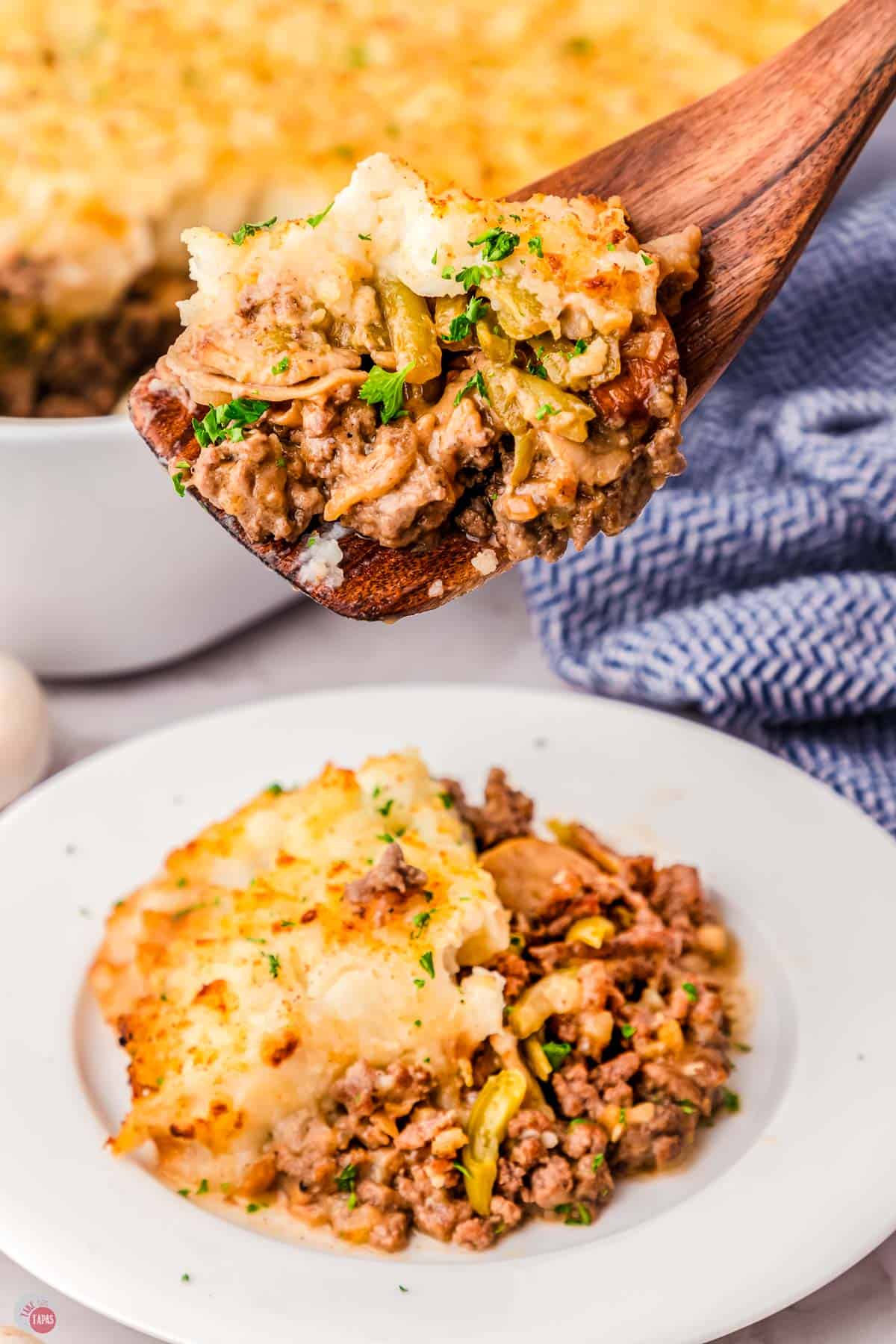 plate of salisbury steak casserole with a wood spoon