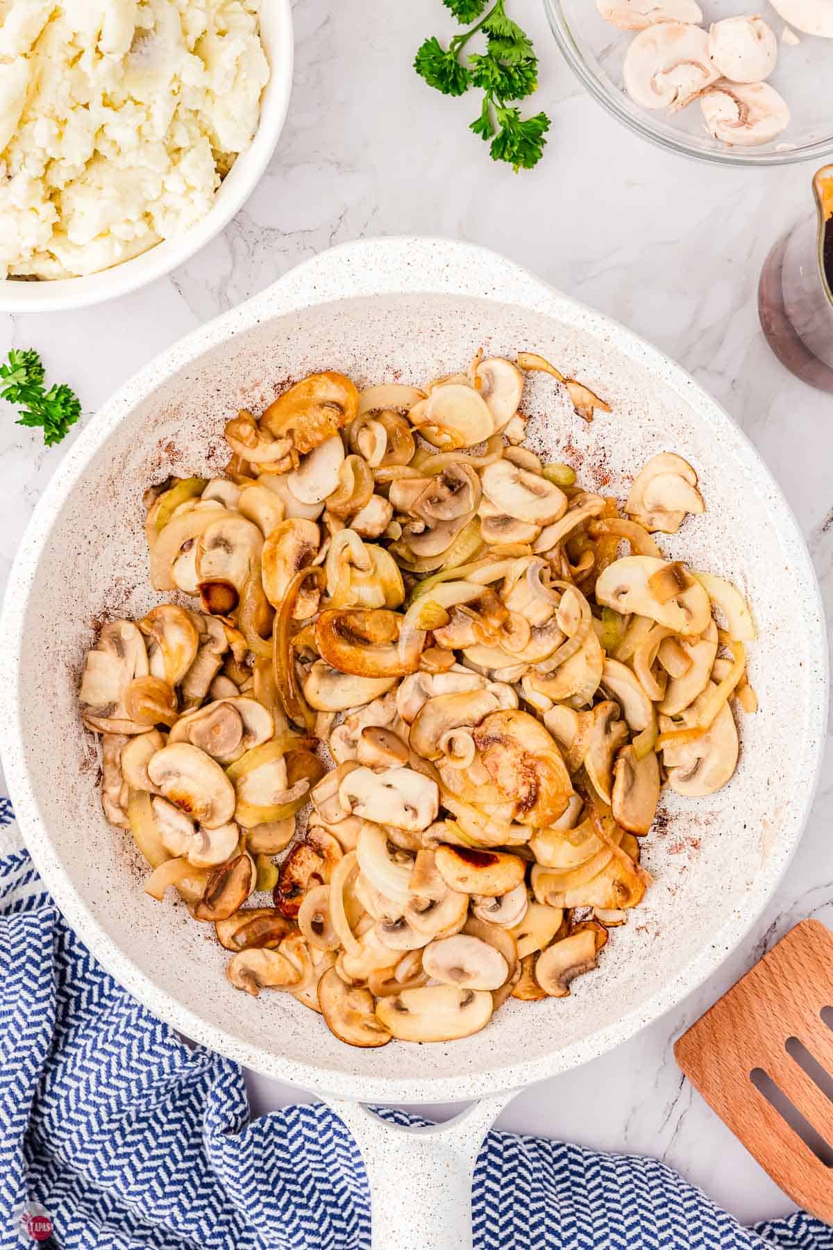 cooked mushrooms in a white skillet