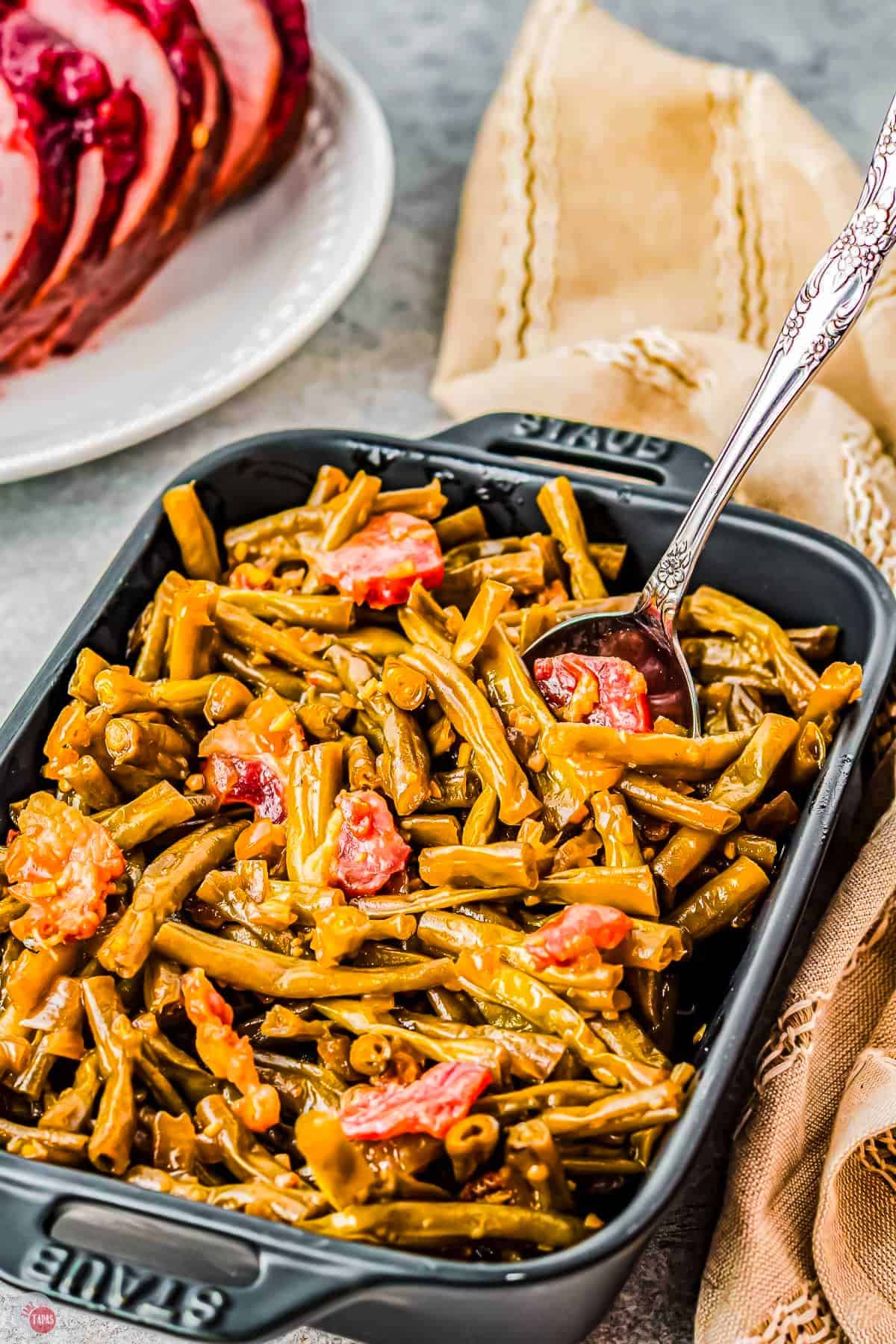 dish of smothered green beans with a spoon in it