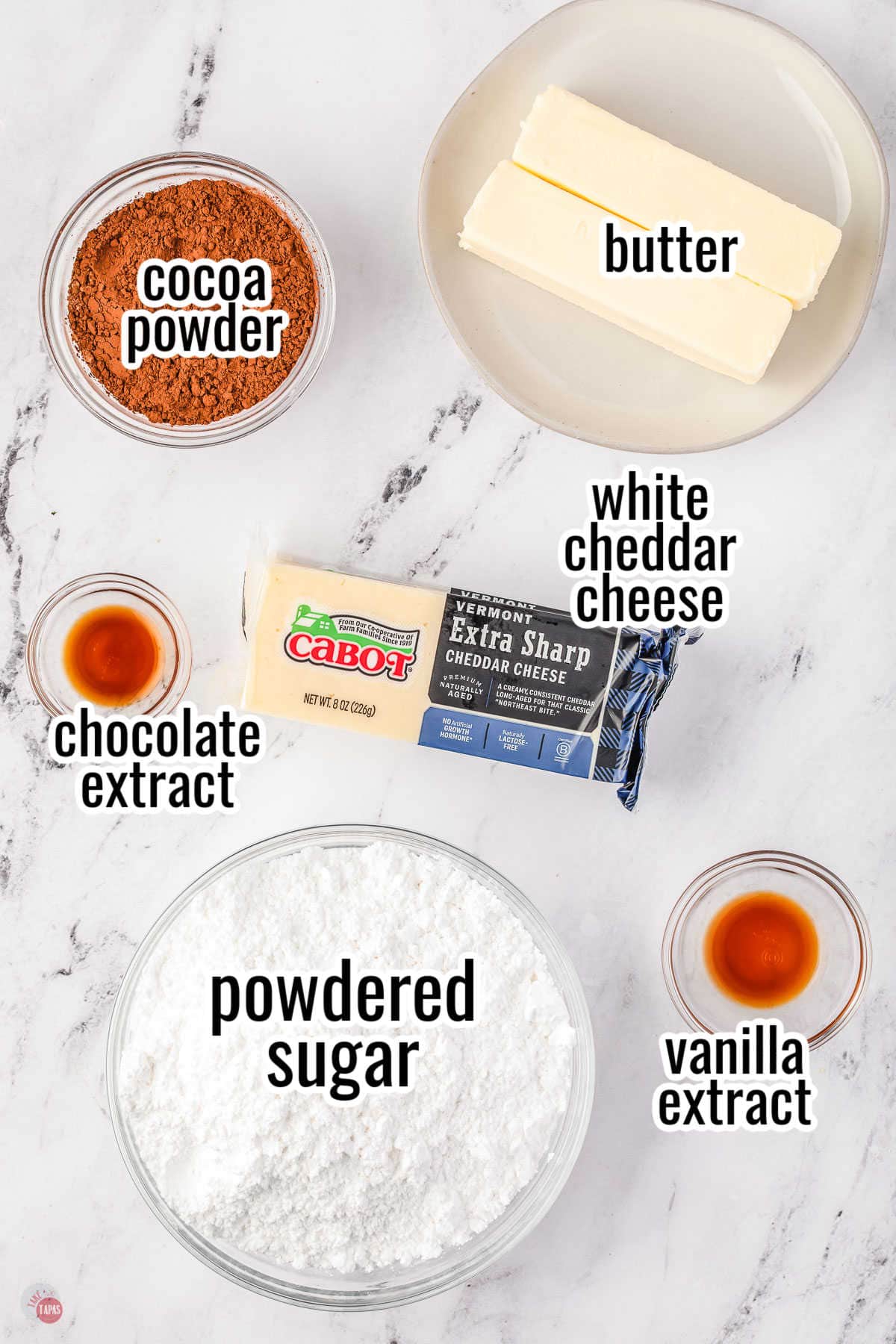 ingredients for a fudge recipe in individual bowls with text overlay labeling them