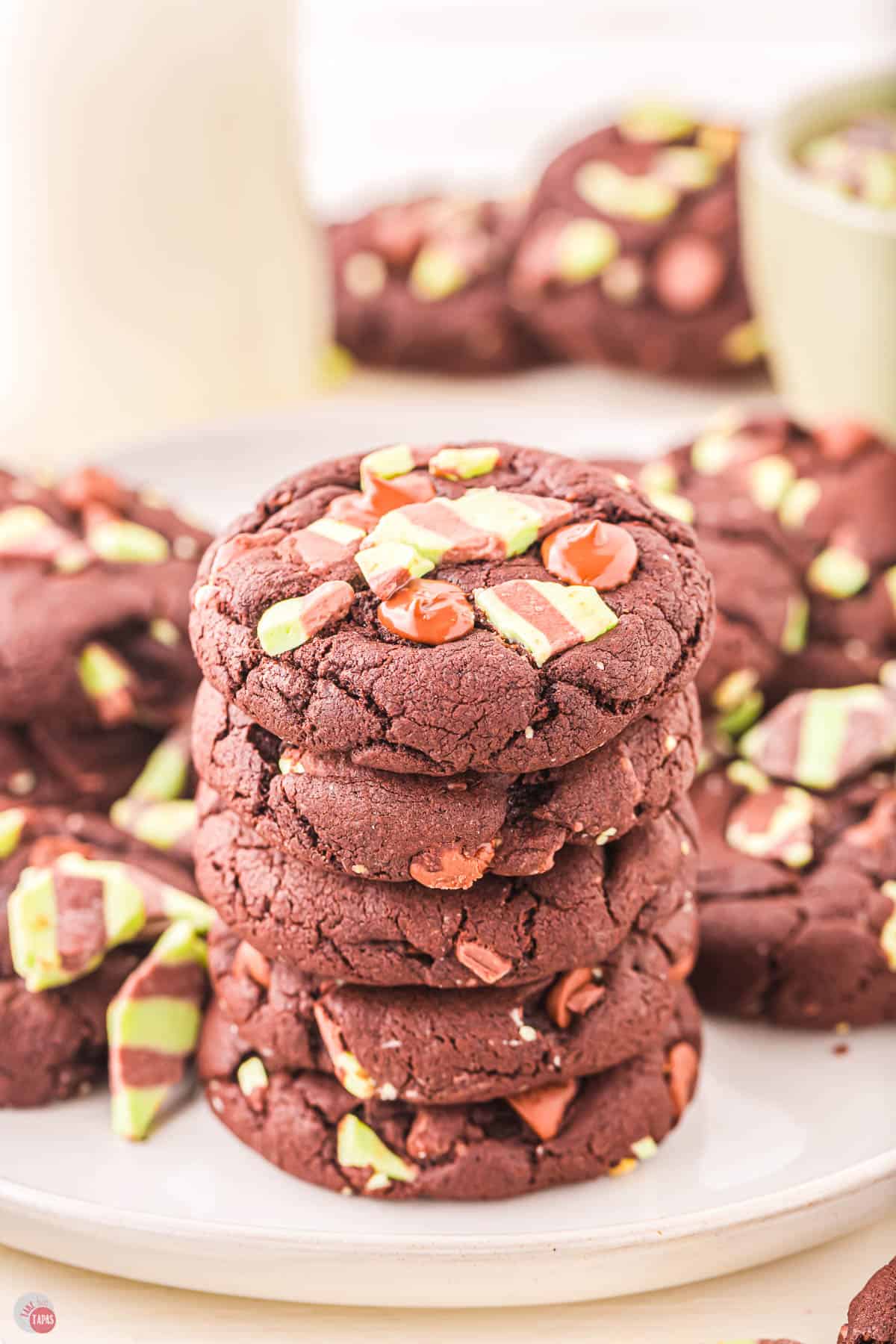 stack of chocolate mint cookies on q piece of parchment paper