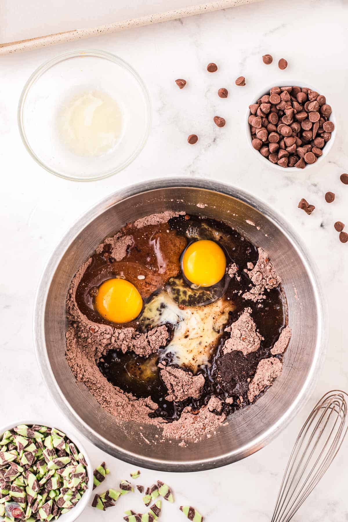 cocoa powder, cake mix, and eggs in a metal bowl