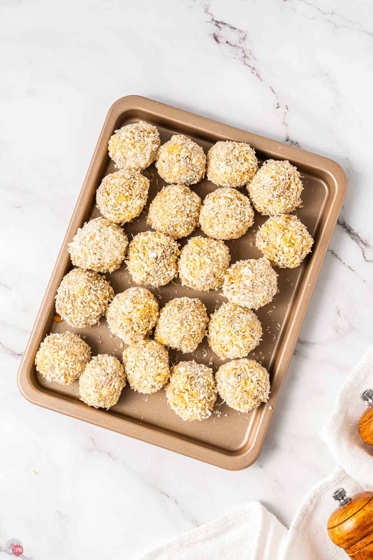 sheet pan with stuffing balls before being deep fried