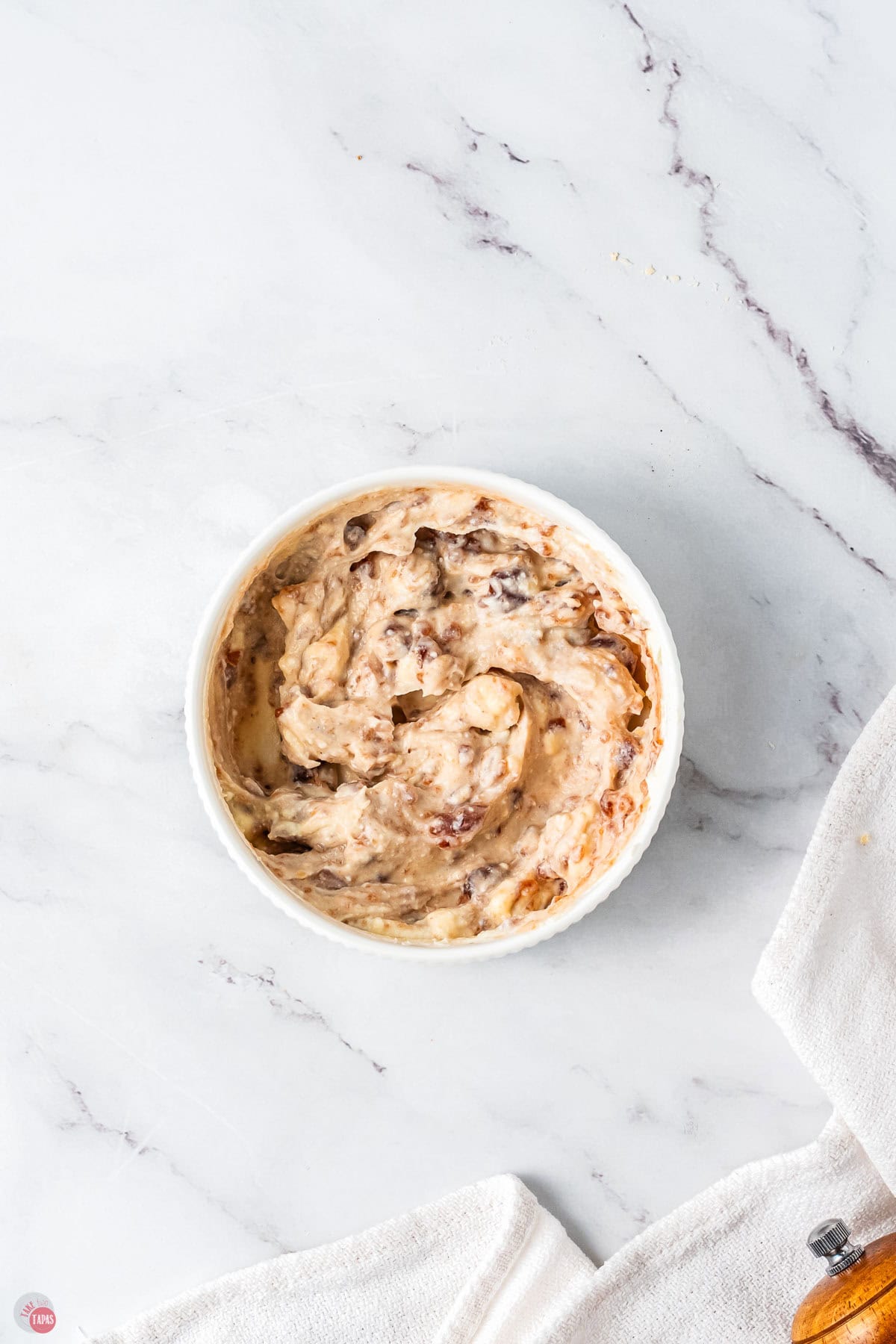 bowl and cranberry dip on a marble backdrop