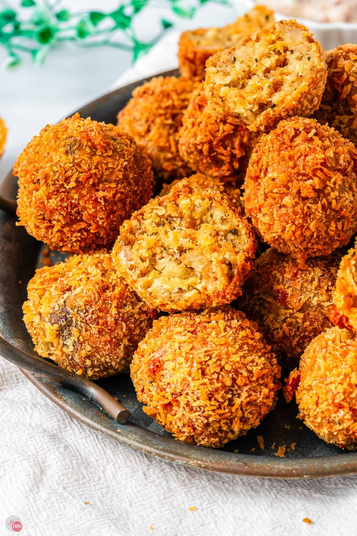 green plate with a pile of stuffing balls on it