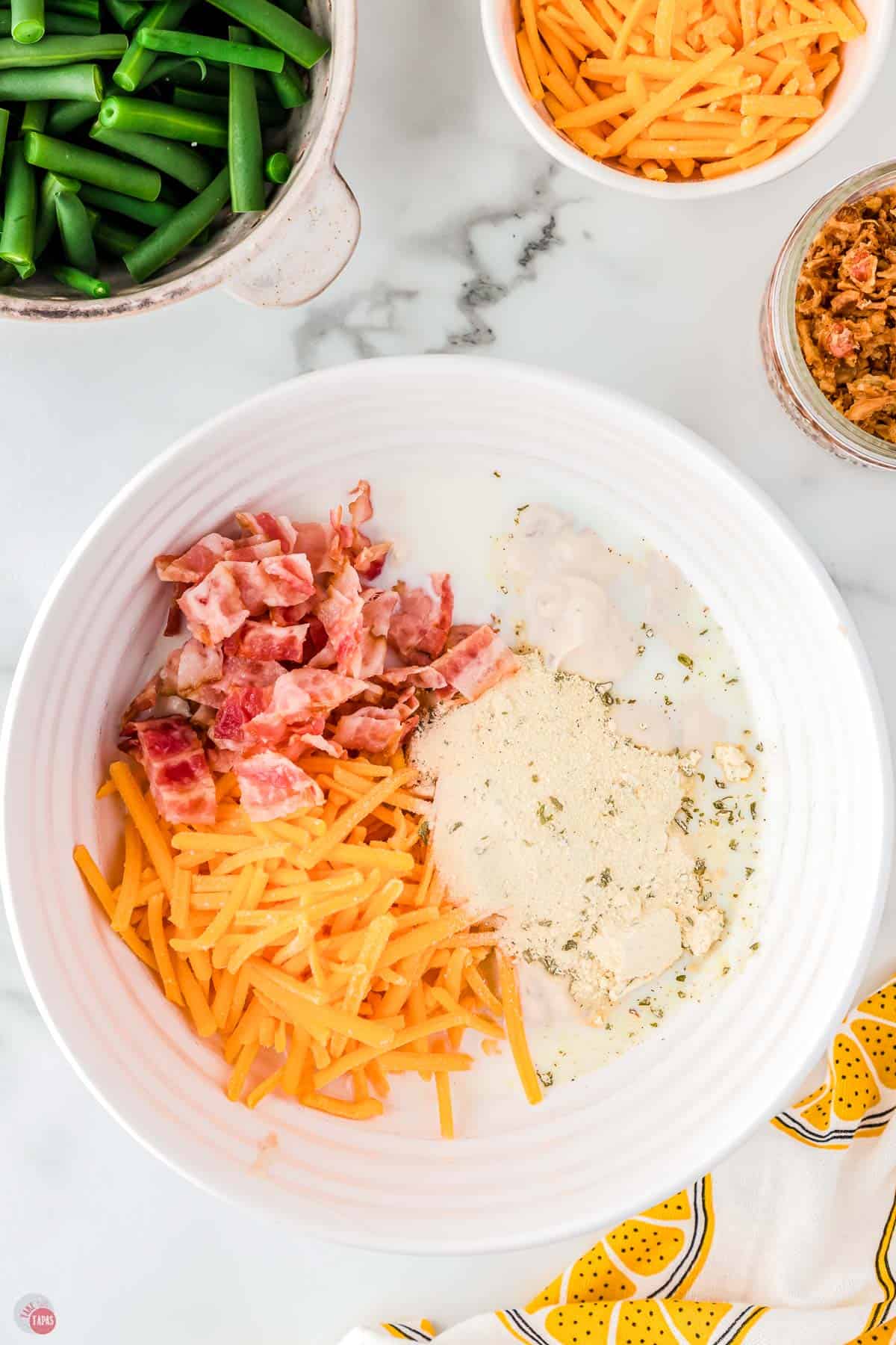 cheese, bacon, and ranch seasoning in a white bowl