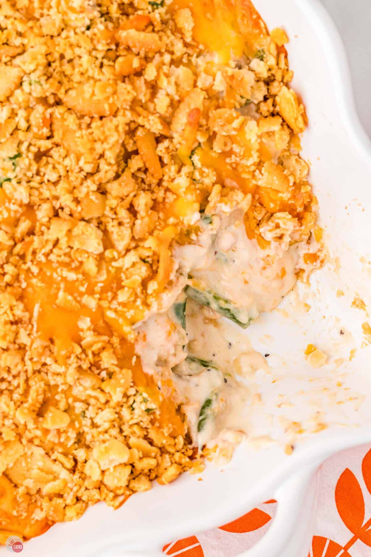 baked casserole with a scoop missing