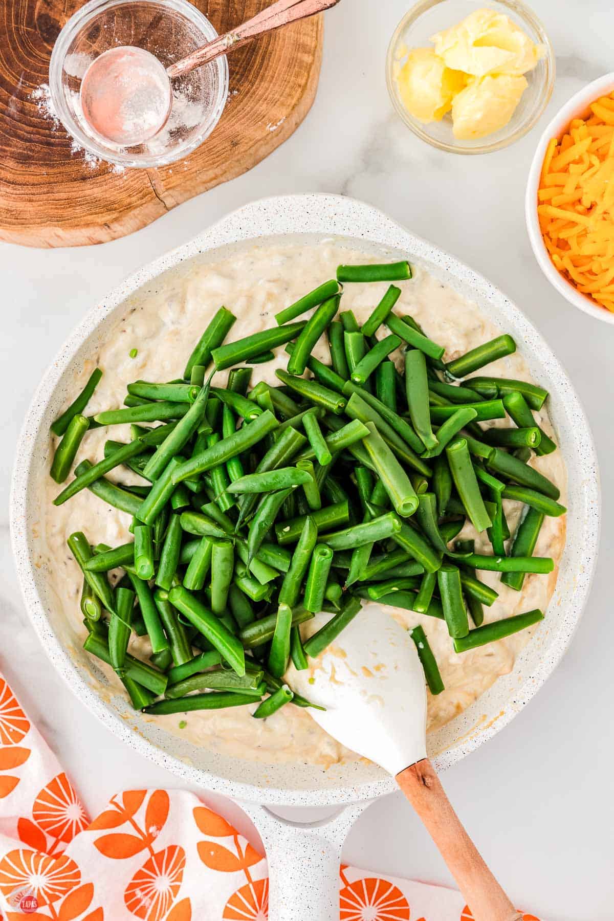fresh green beans on top of a skillet with a creamy sauce