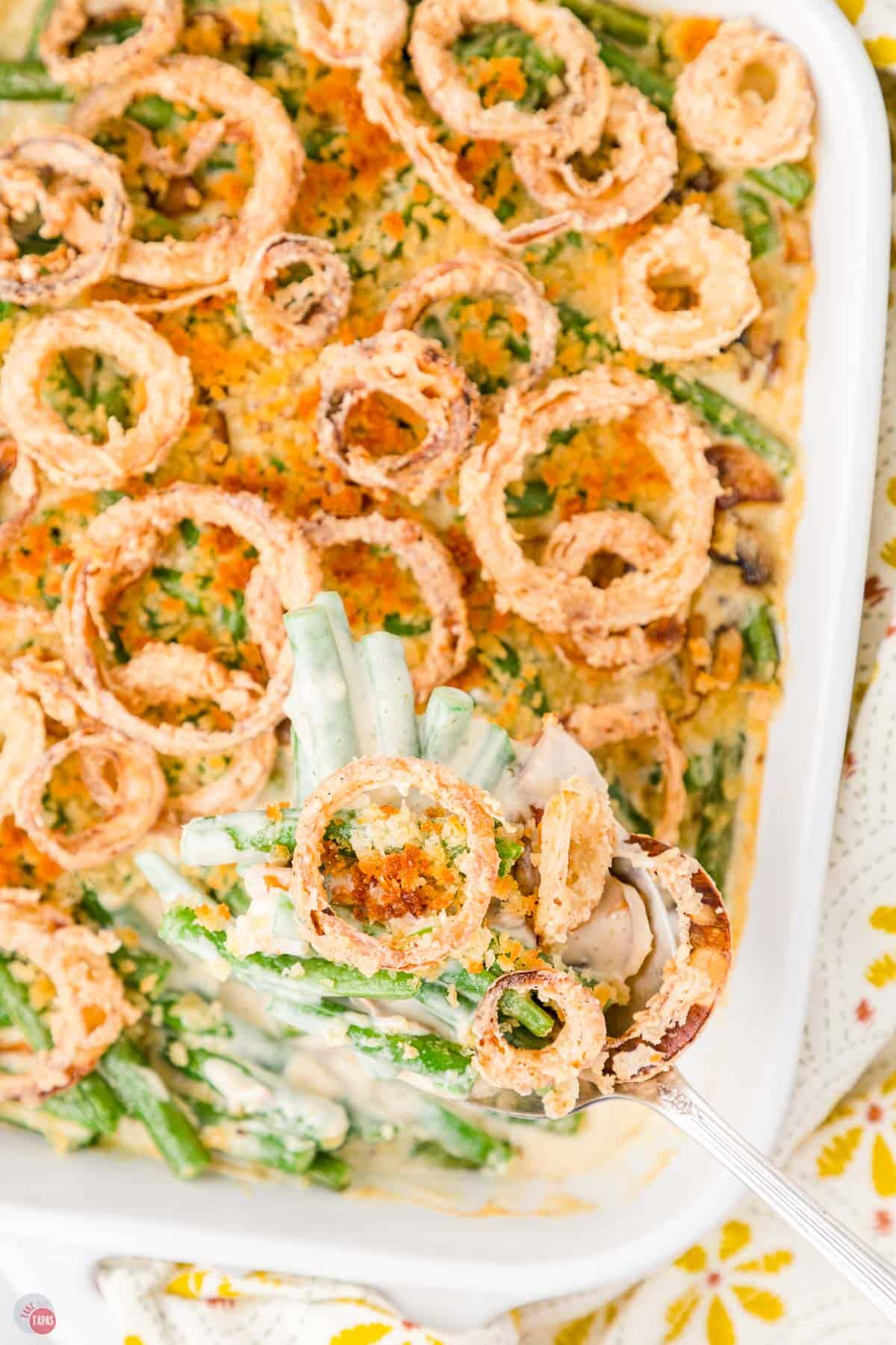 overhead picture of green bean casserole with onion rings on top