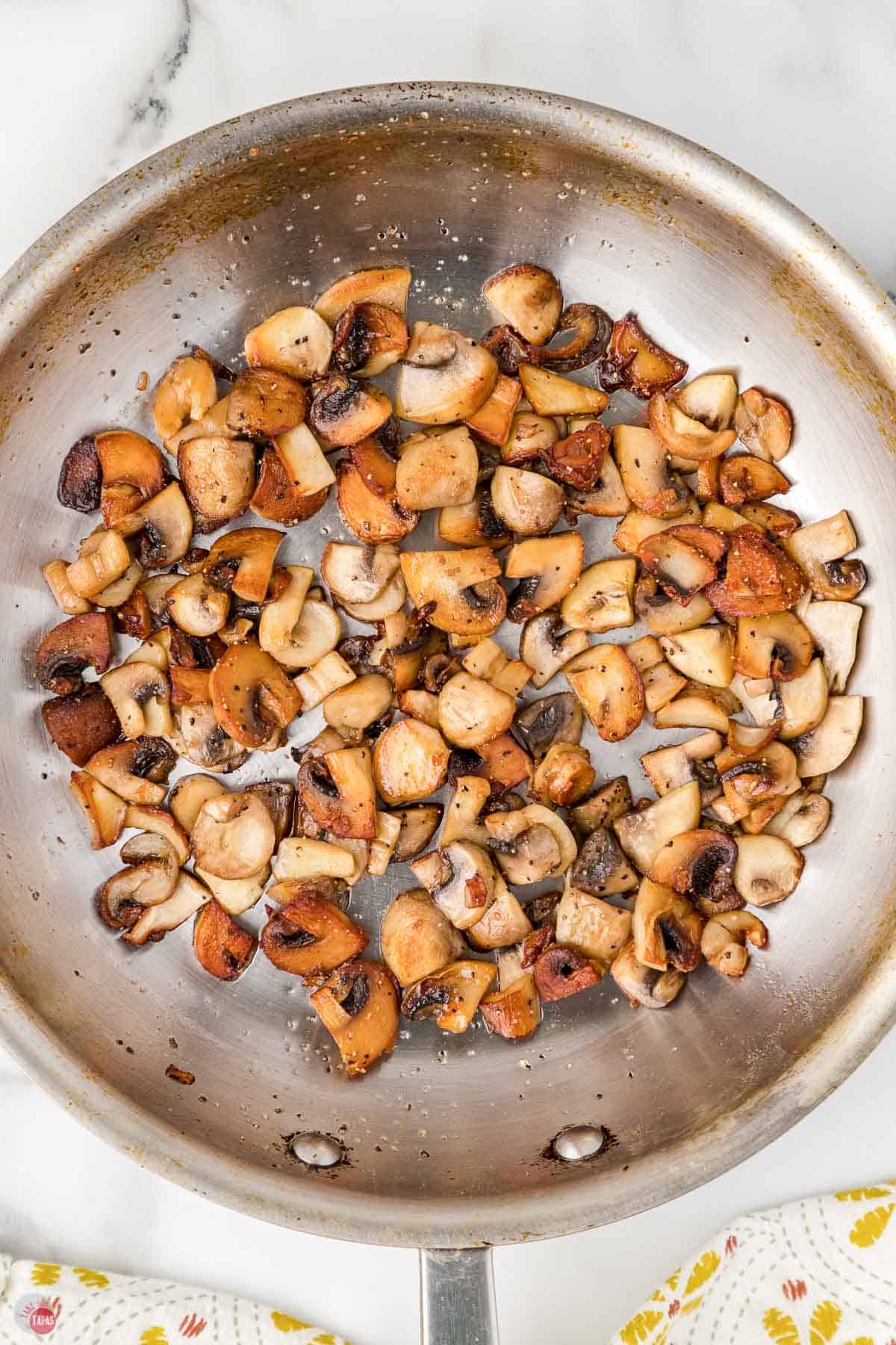 mushrooms cooking in a skillet