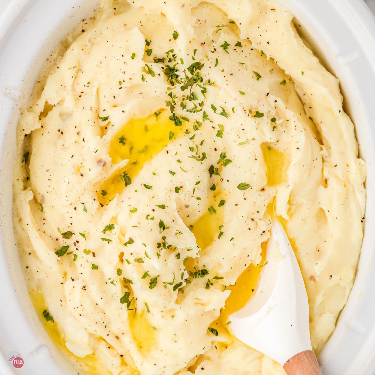 white bowl of mashed potatoes with a spatula