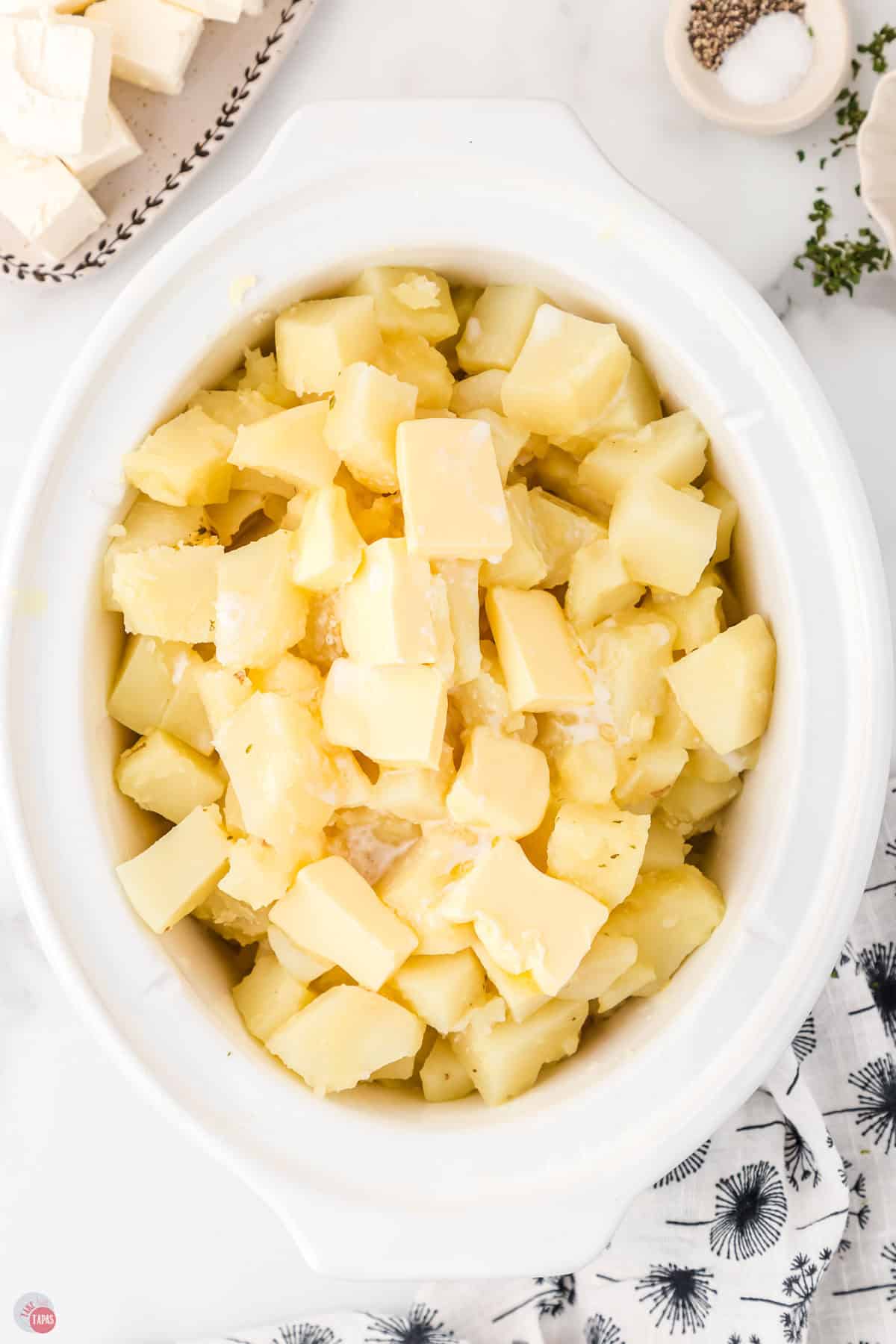 boiled potatoes in a white crock pot