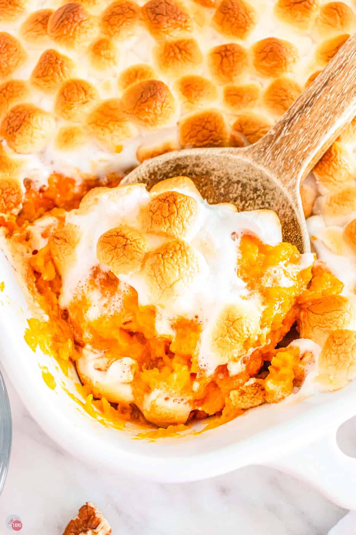 close up of spoon with sweet potatoes and marshmallows