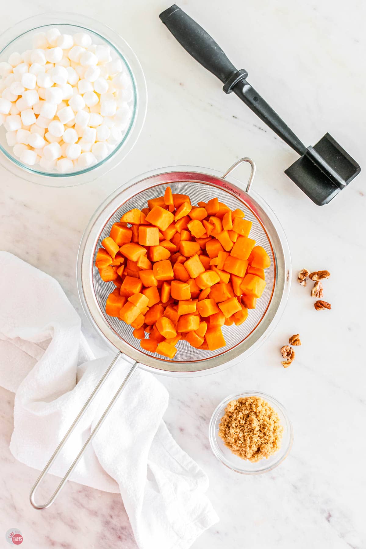 metal strainer filled with diced sweet potatoes