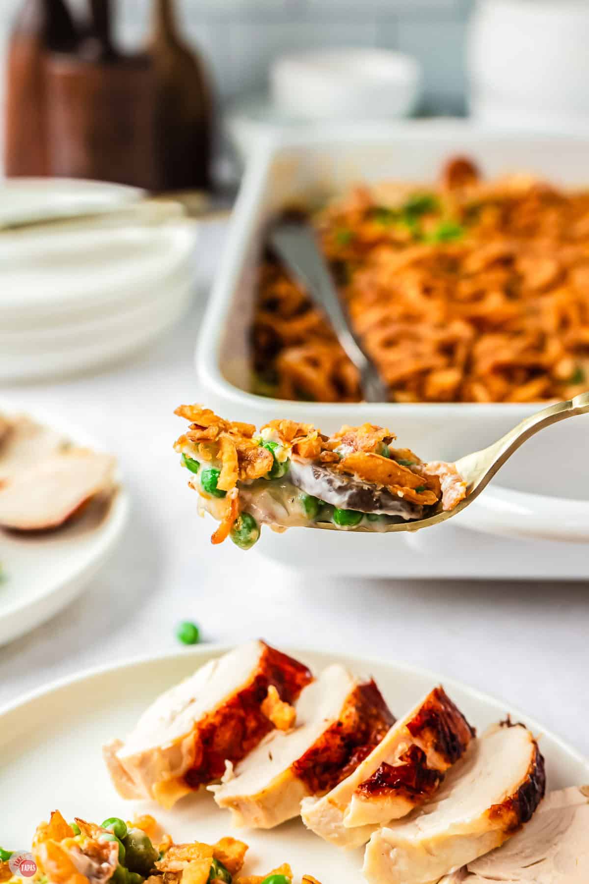 close up of fork with a bite of peas and mushrooms