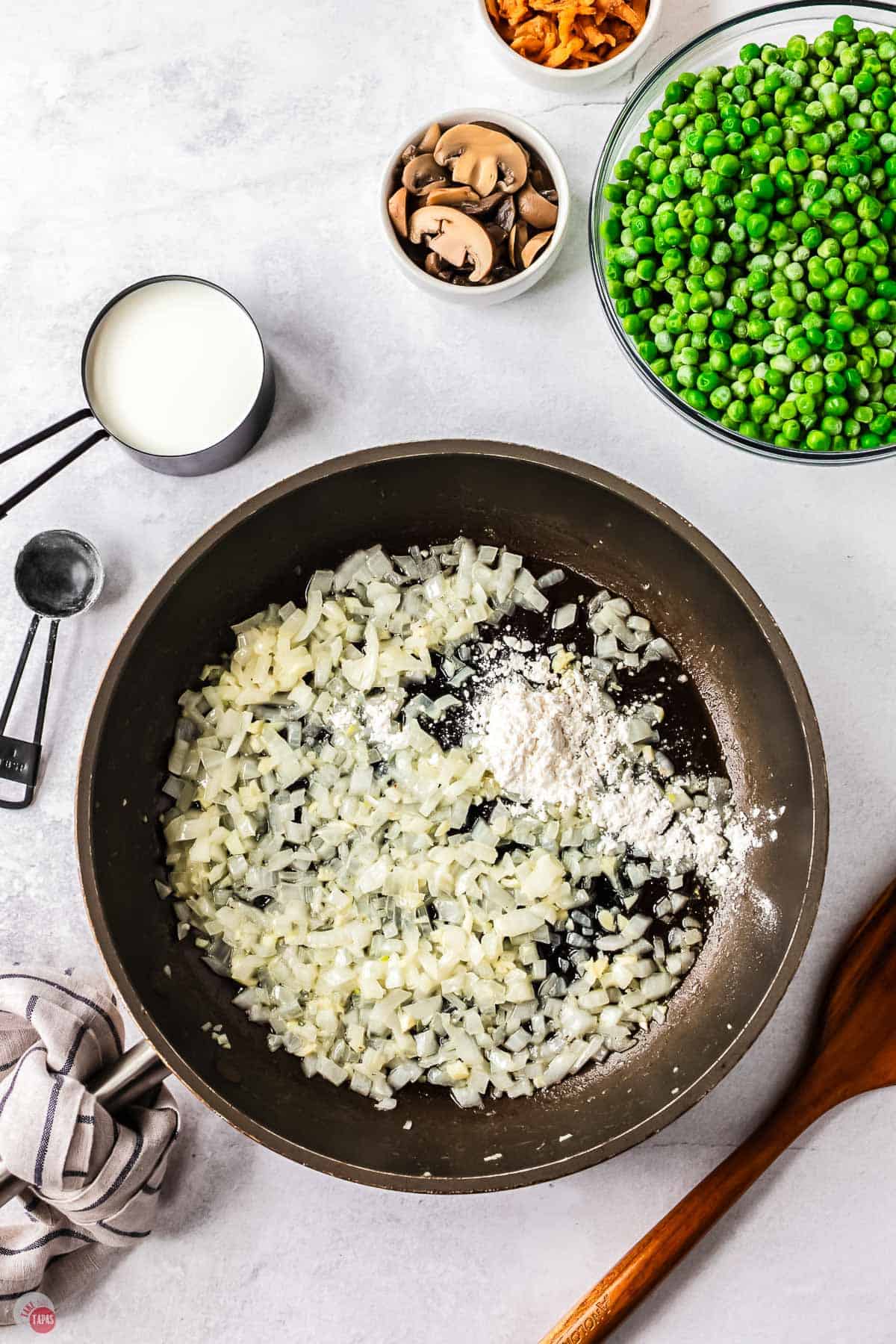 skillet with onion cooking with flour sprinkled on them