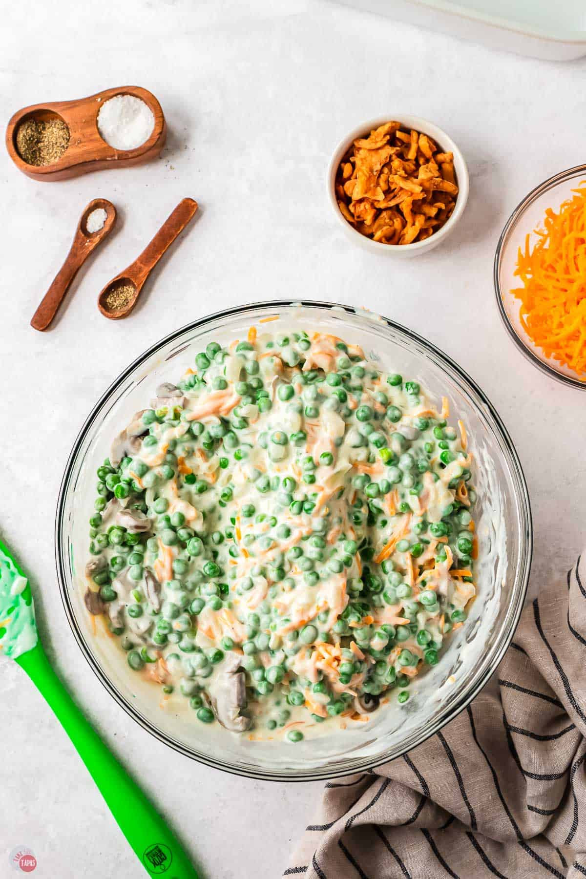 peas, cheese, and cheese sauce in a bowl
