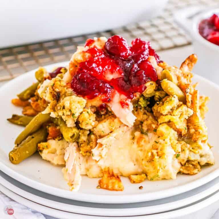 Thanksgiving casserole on a stack of 3 white plates