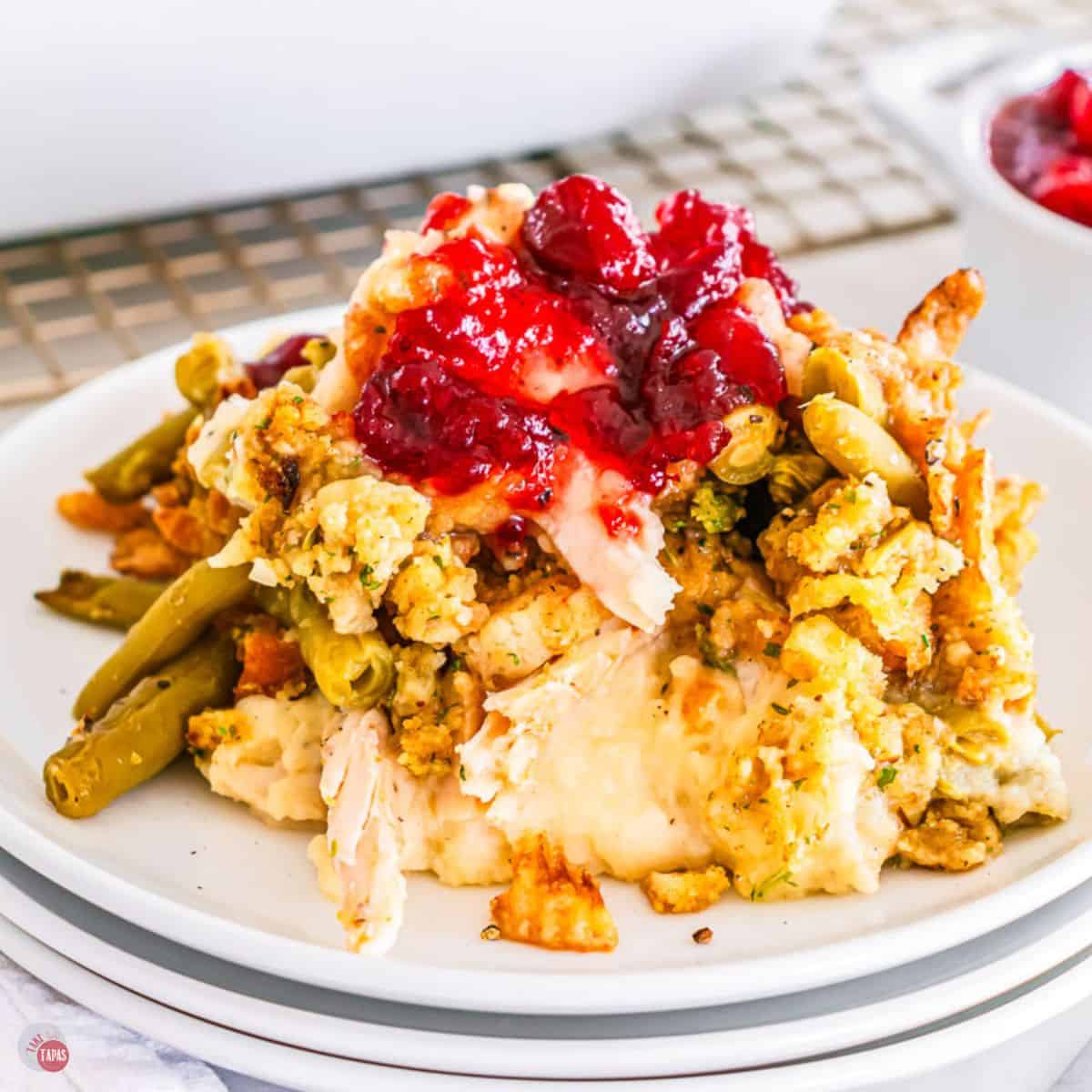 Thanksgiving casserole on a stack of 3 white plates