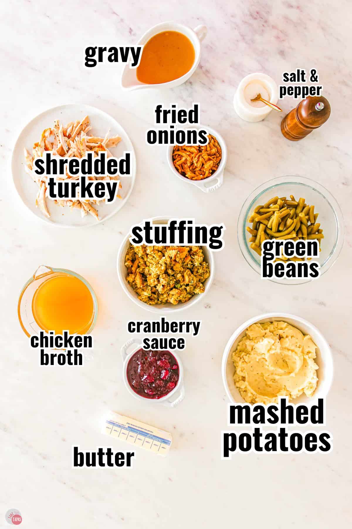 ingredients for a leftovers casserole in individual bowls with text overlay labeling them