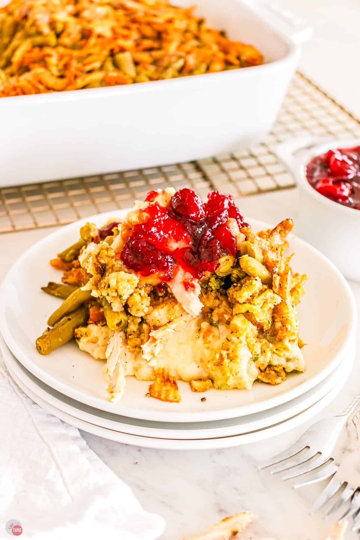 stack of 3 plates with mashed potatoes and green beans on top