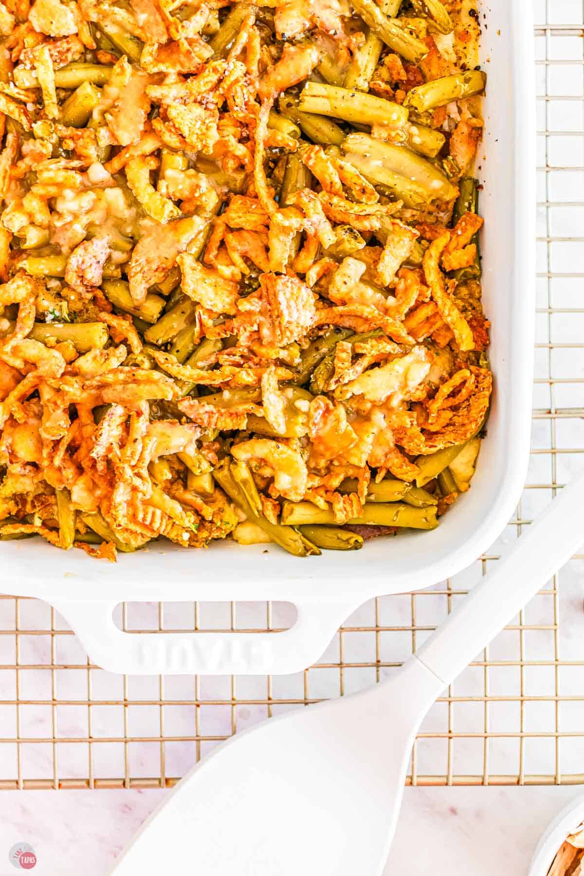 close up of Thanksgiving leftovers casserole in a white casserole dish on a wire rack
