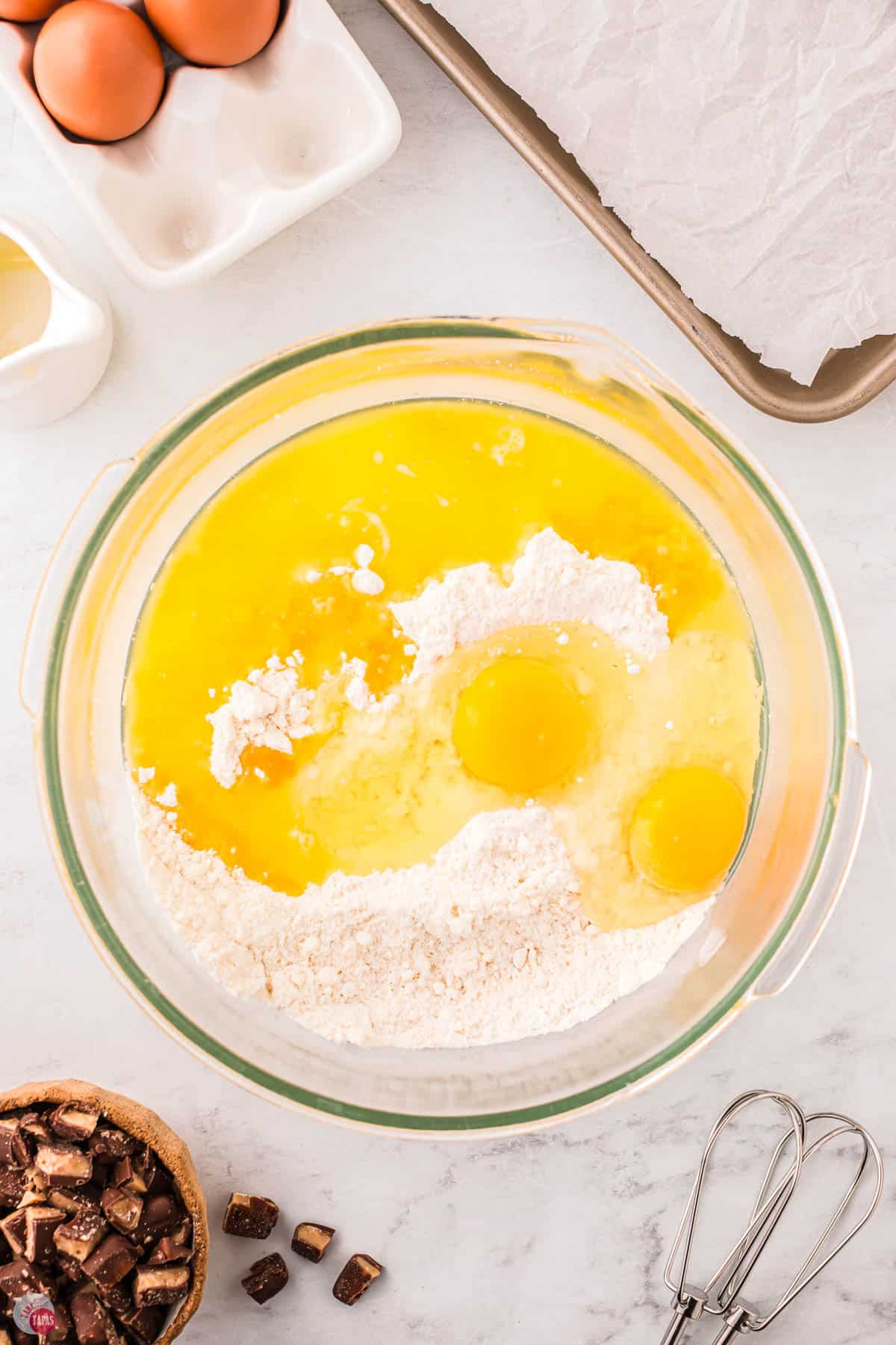 flour, eggs, and butter in a clear bowl