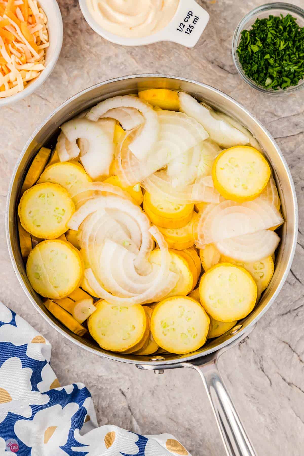 cut squash and onions in a pot