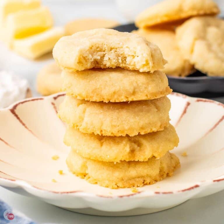 stack of 5 sugar cookies with the top one missing a bite