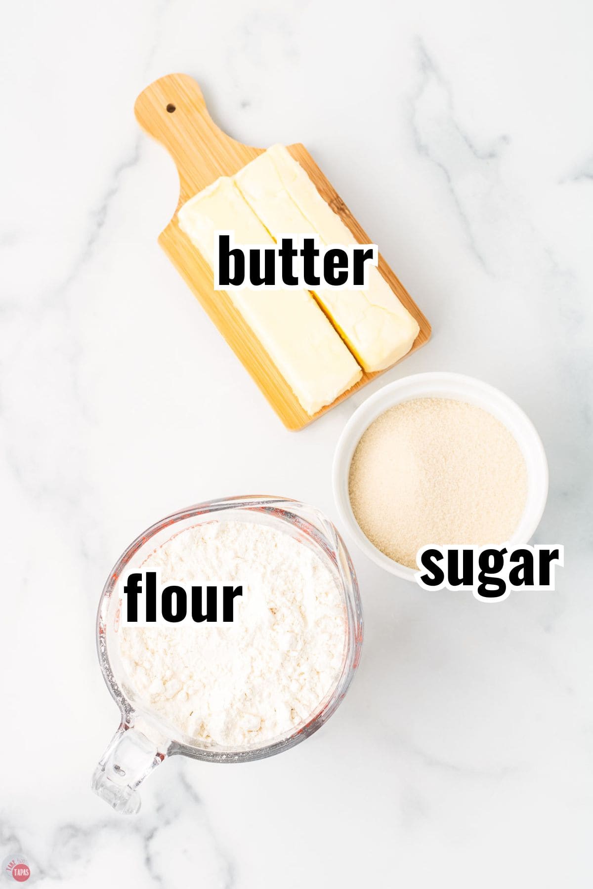 ingredients for a cookie recipe in individual bowls with text overlay labeling them