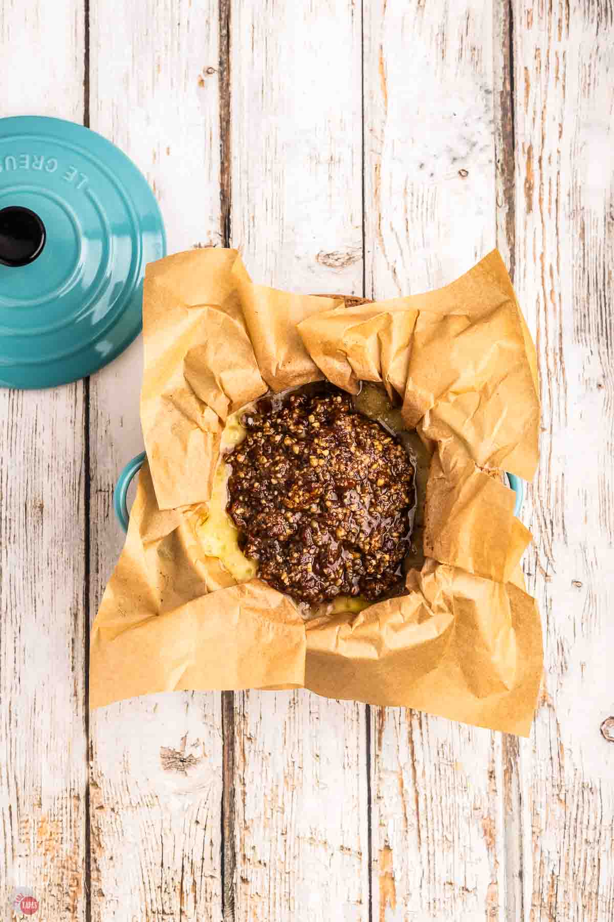 baked brie in square of parchment paper