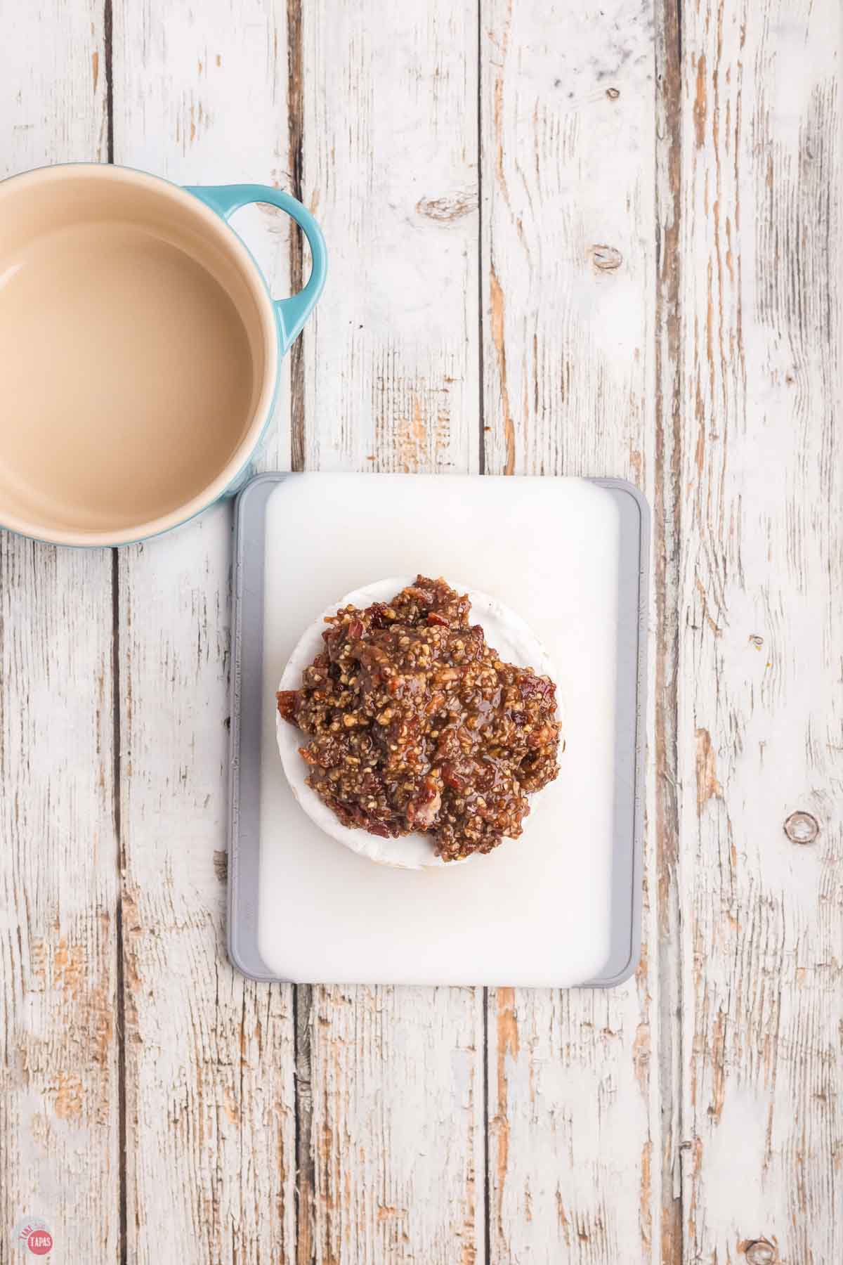 wheel of brie topped with bacon and pecans