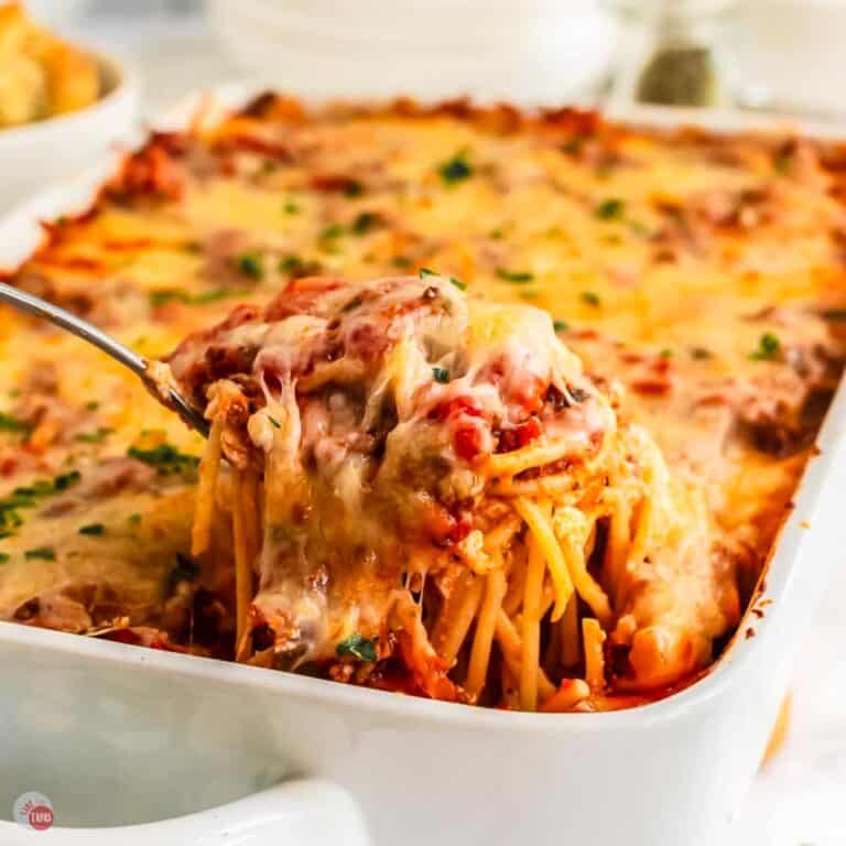 spoon scooping spaghetti casserole out of a baking dish