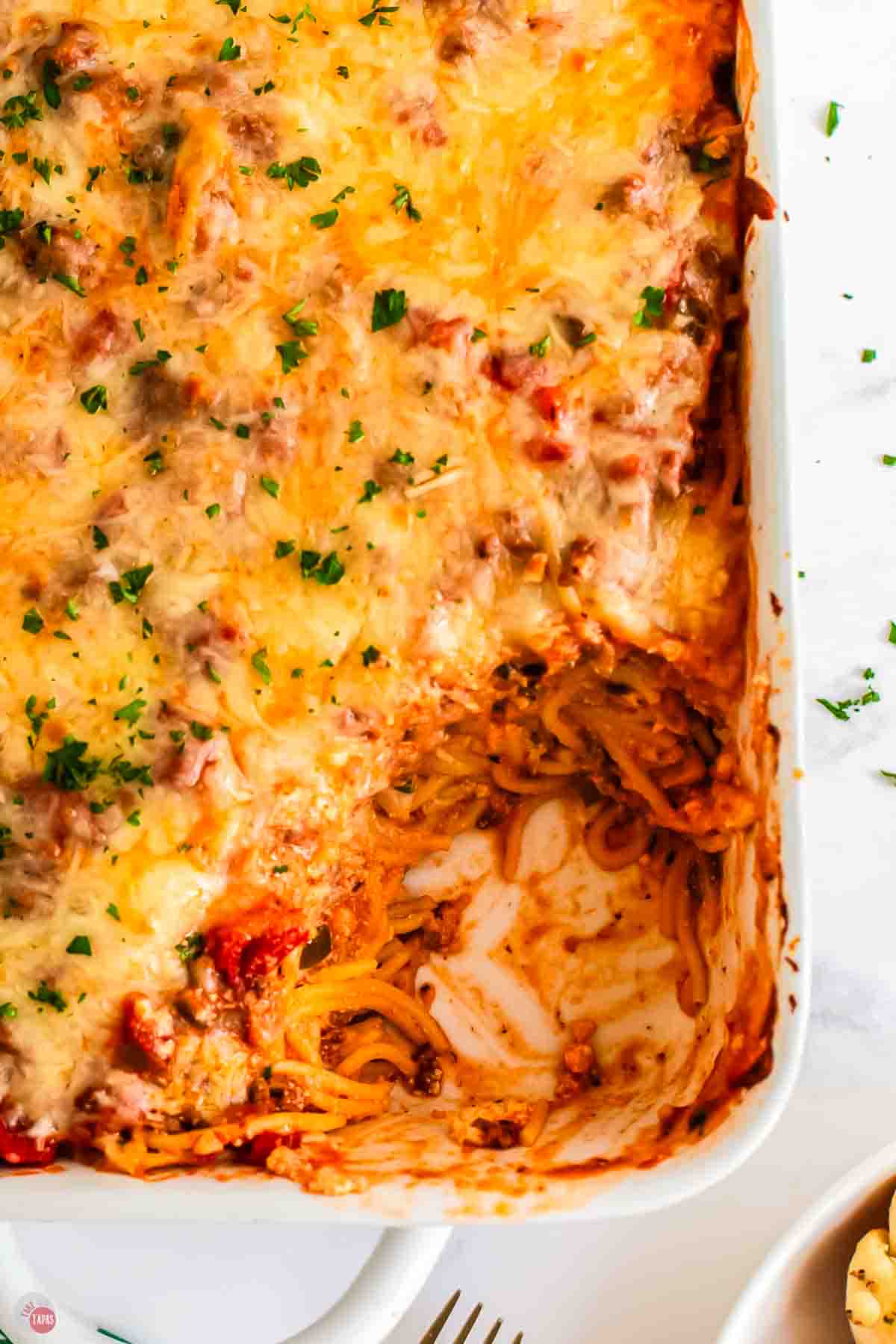 close up of spaghetti casserole missing a scoop