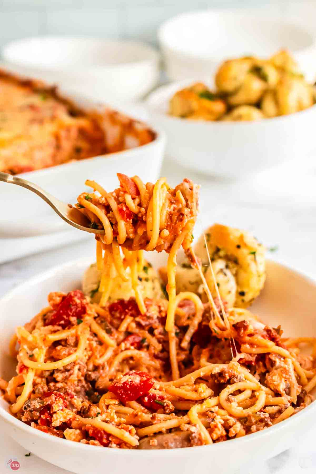 fork with bite of spaghetti and cheese