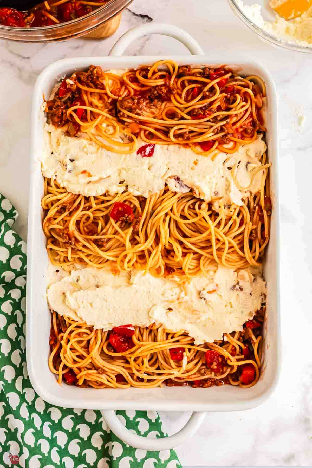 casserole dish with layers of pasta and ricotta cheese