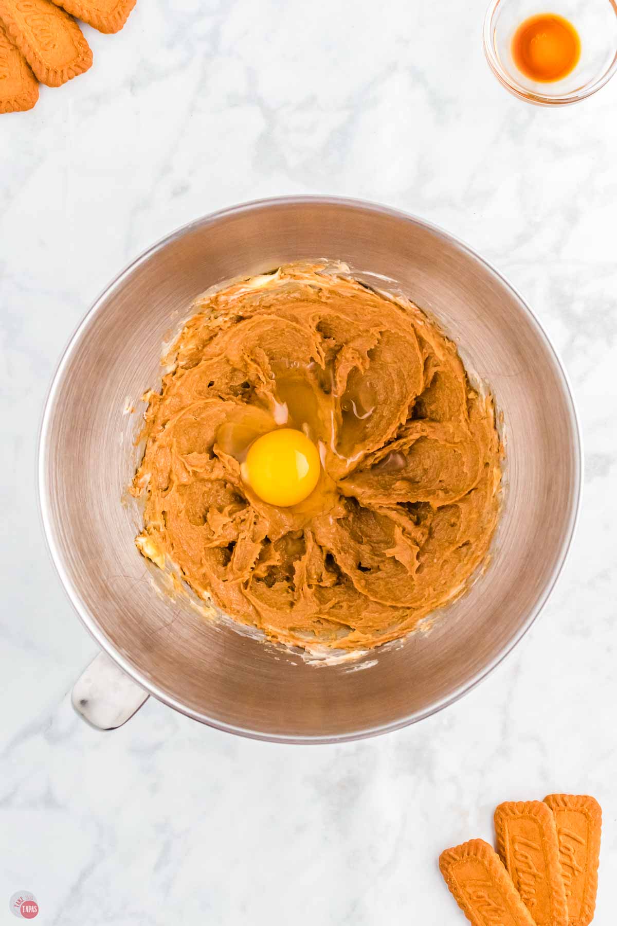 silver mixing bowl with creamed butter and an egg yolk