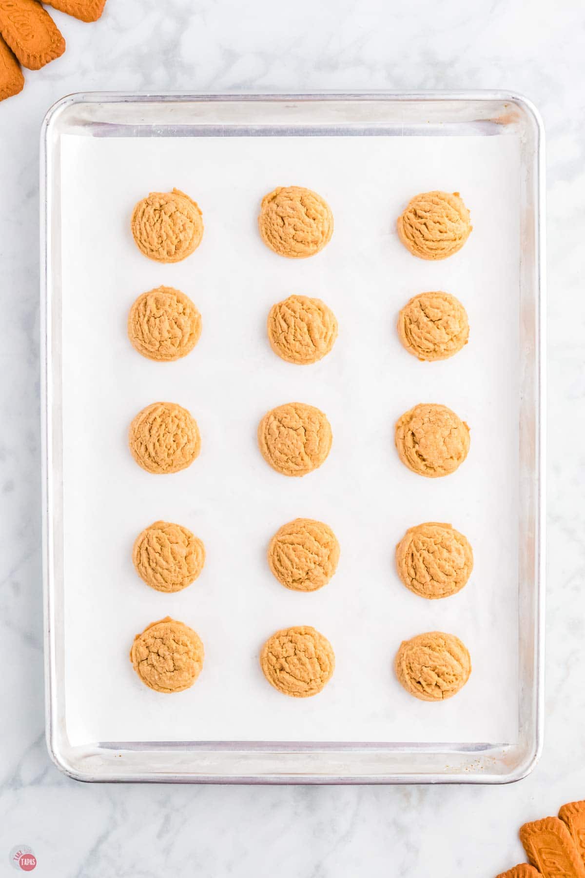 baking sheet with parchment paper topped with baked cookies