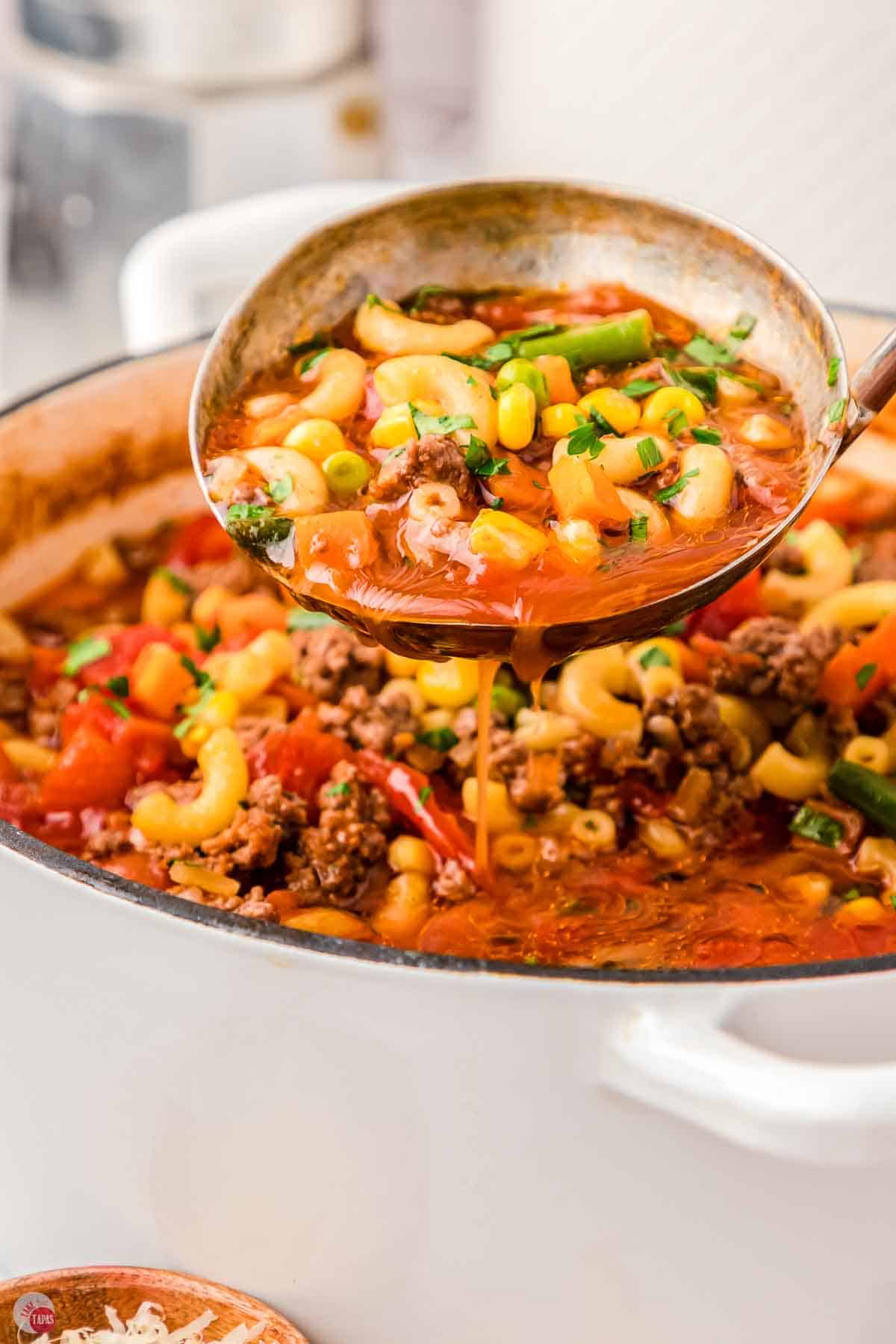 pot of soup with a ladle pouring the soup back into the pot