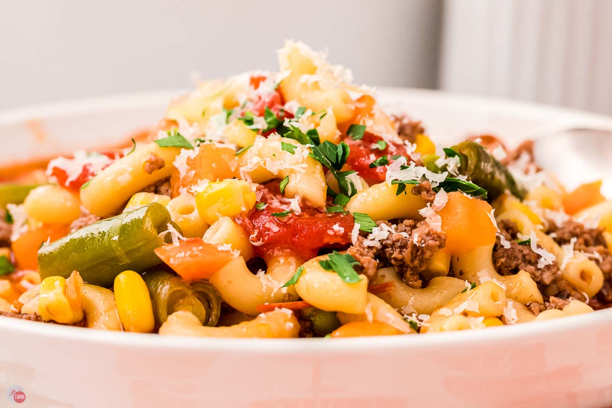 close up of bowl of soup topped with grated parmesan cheese